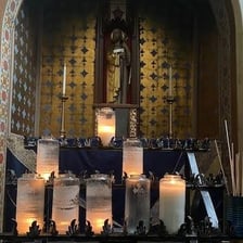 Candles arranged in a religious setting to represent sacredness.
