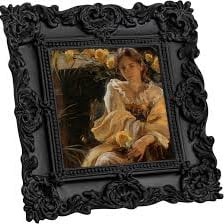 A picture frame decorated with carved ornamental details.