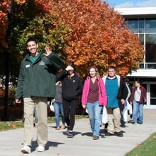 A guide leading visitors on a college campus tour.