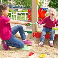 Children having a playful argument on a school playground.