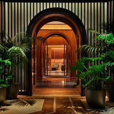 People entering an exclusive venue, suggesting privileged insiders.