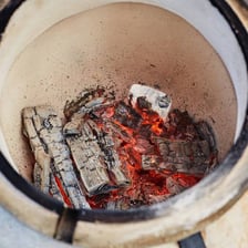 Ash residue visible inside a traditional tandoor oven.