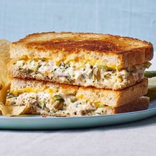 A toasted tuna melt sandwich with melted cheese