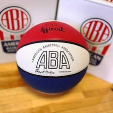Players competing in a 1970s American Basketball Association game.