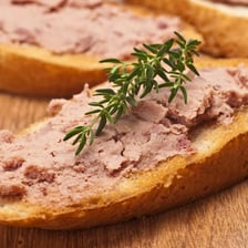 Pâté spread on slices of toast.