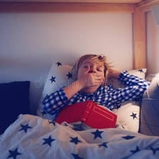 A person preparing to sleep in a bedroom.