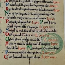 A person carefully correcting detailed text in a manuscript.
