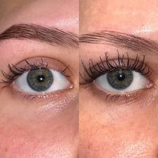 A mascara brush applying cosmetic to eyelashes