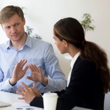 A person interrupting a discussion to point out a minor detail