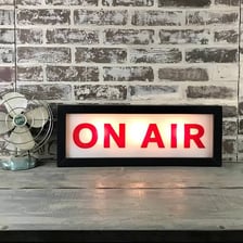 A broadcasting studio with an illuminated On Air sign