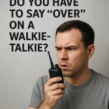 A radio operator speaking into a handheld two-way radio.