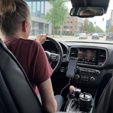 A passenger getting a lift in a car