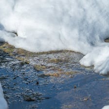 A piece of ice melting as it thaws.