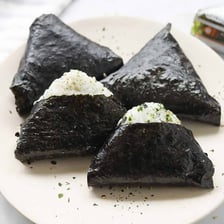 Japanese onigiri rice balls wrapped in dark sheets of nori.