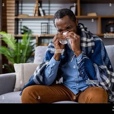A person resting with tissues while feeling unwell.