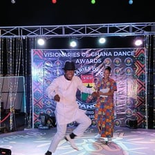 A performer giving an energetic performance on stage.