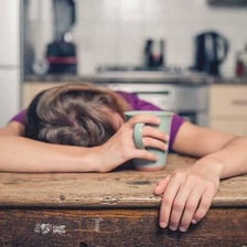 A tired person resting with eyes closed.