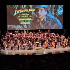 Musicians performing onstage during a theater intermission.