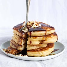 A stack of hotcakes or pancakes served with syrup.