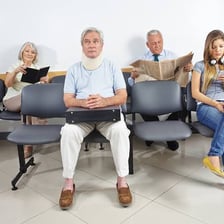 A person sits calmly while waiting in a waiting room.