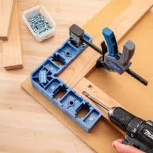 Hand drill and clamp displayed as workshop tools