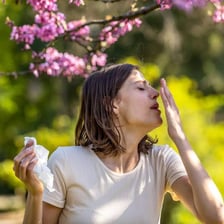 Person sneezing during allergy season