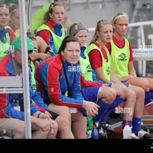 Second-string athletes sitting together on a team bench
