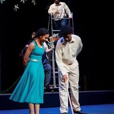 A performer presenting a routine on a theater stage