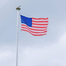 A flag flying from a vertical pole