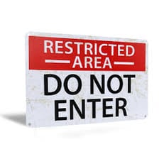A warning sign asks people to stay out of a restricted area.