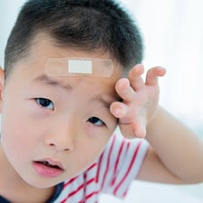 A child wearing a bandage after a minor injury