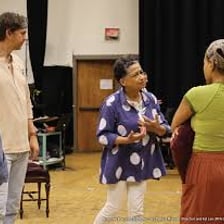 Theater director working with actors during a rehearsal