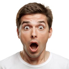 A person making an unusual reaction while nearby people look surprised.
