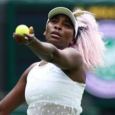 Venus Williams playing tennis on a Wimbledon court