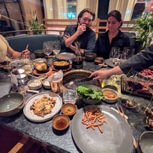 People eating together around a table