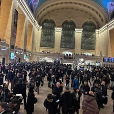 A large crowd arriving at a train station.