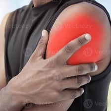 A person rubbing a shoulder that appears sore or achy.