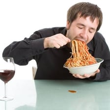 A person eating food quickly.