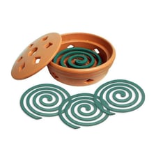 A lit spiral mosquito coil emitting a thin plume of smoke.
