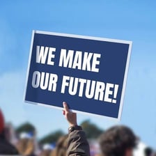 A protester holding a sign opposing a cause