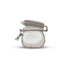 A lid covering the opening of a glass jar.