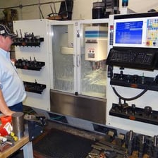 A technician installing updated components in an older machine.