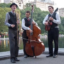 Three musicians performing together as a small jazz combo.