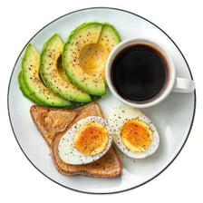 A plate of brunch food with eggs, toast, and coffee