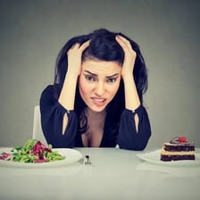 A person looking at food they strongly want to eat.