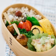 A Japanese bento box containing neatly arranged foods