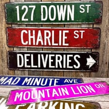 A narrow urban alley with a directional sign.