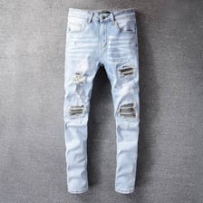 A close view of denim jeans with deliberate rips at the knees