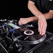 A disc jockey working at a pair of turntables
