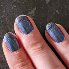 A manicure with visibly fresh wet nail polish